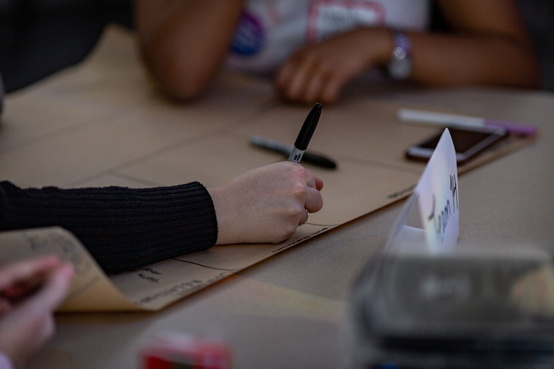 Hands mapping ideas during a strategy workshop